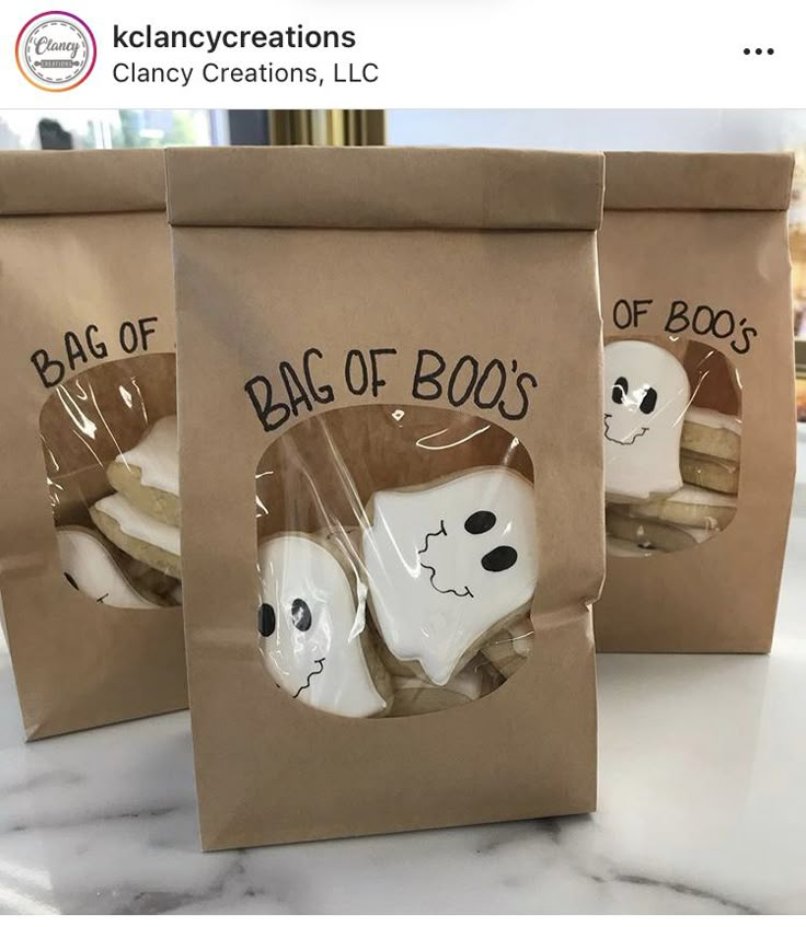 two bags of boo's with ghost faces on them sitting on a counter top