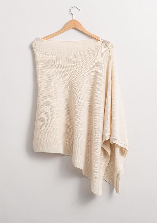 a white sweater hanging on a hanger