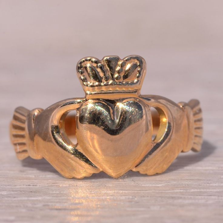 This Stunning Piece, Known As The Irish Claddagh, Is A Beautifully Crafted Claddagh Ring Signed By Solvar. The Ring Showcases The Traditional Claddagh Design, Featuring Two Hands Holding A Heart Topped With A Crown, Symbolizing Love, Loyalty, And Friendship. This Ring Is Crafted In 14 Karat Yellow Gold, Adding A Classic And Elegant Touch To Its Symbolic Design. This Exquisite Ring Is Currently A Finger Size 8 Yet Can Be Adjusted To Any Finger Size For An Additional Charge Upon Request, Ensuring A Perfect Fit. Claggagh Ring, Irish Claddagh, Heart Top, Claddagh Rings, Womens Jewelry Rings, Gold Color, Yellow Gold, Women Jewelry, Signs