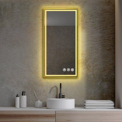 a bathroom with a sink, mirror and lights on the wall above it's counter