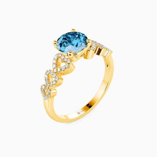 a yellow gold ring with an oval blue topazte and diamonds