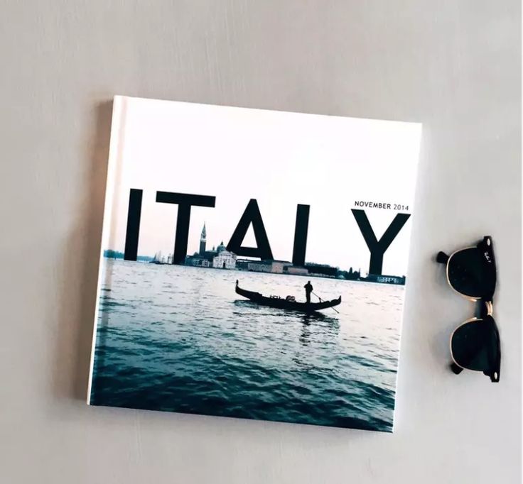 a book with sunglasses on top of it next to a pair of sunglasses