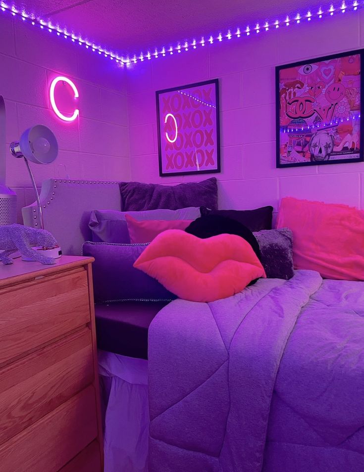 a bedroom with purple and pink lights on the walls