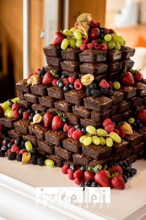 a cake made out of brownies with berries and grapes on top is shown in the instagram