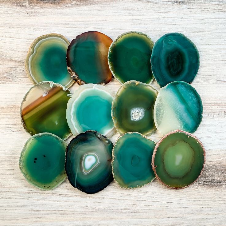 several different types of agate glass sitting on top of a wooden table