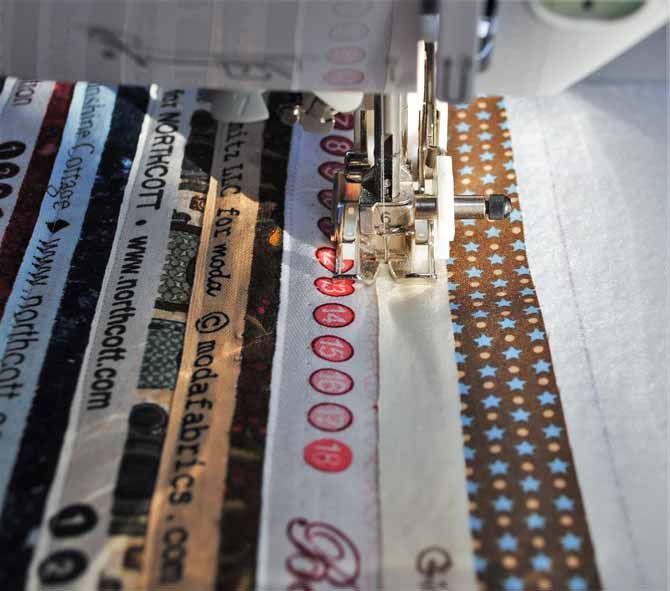 the sewing machine is next to several different types of ribbons on it's table