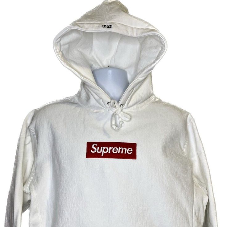 Product Description Released As Part Of The Supreme's Fall/Winter 2021 Week 9 Delivery, This White Box Logo Hoodie Is Made From The Brand's Popular Heavyweight Cotton Crossgrain Fleece Material And Features A Red Logo On The Chest Of A White Sweatshirt. This Hoodie Was Released As A Part Of The First Traditional Supreme Box Logo Hoodie Delivery Since 2017. White Cotton Hoodie With Logo Detail, White Cotton Hoodie With Logo, White Cotton Hoodie With Embroidered Logo, White Logo Hoodie For Winter, White Logo Hoodie For Fall, White Hoodie With Embroidered Logo For Winter, White Streetwear Hoodie With Logo, Winter White Hoodie With Embroidered Logo, White Logo Sweatshirt For Winter