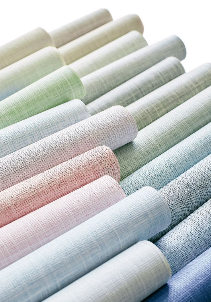 rolled up linens laid out in rows on top of each other with different colors