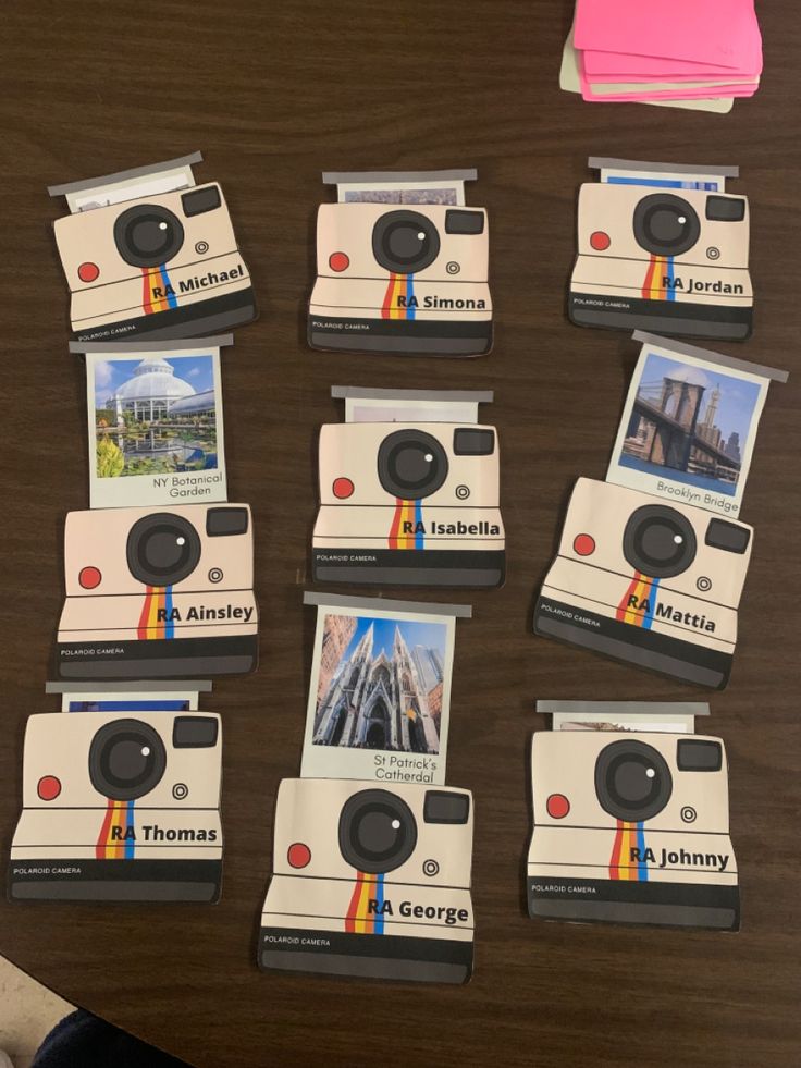 several polaroid cameras sitting on top of a wooden table