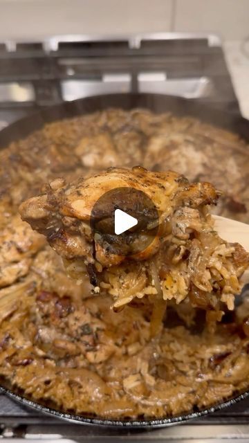 a pan filled with food being cooked on top of an open stove burner and spatula