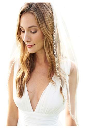 a woman in a wedding dress wearing a veil