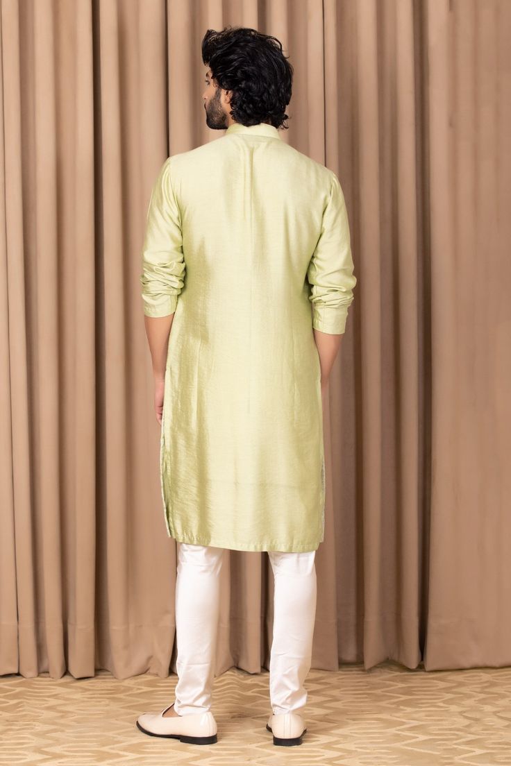 Mint green straight kurta with embroidery on the front. Comes with an ivory churidar.
Component: 2
Pattern: Embroidered
Neckline: Mandarin Collar
Sleeve Type: Straight Long
Fabric: Cotton and Silk
Color: Green
Other Details: 
Front button placket
Note: Pant worn by the model is not for sale
Occasion: Mehendi and Puja - Aza Fashions Green Anarkali With Naqshi Detailing, Semi-stitched Green Kurta With Naqshi, Semi-stitched Pista Green Kurta With Naqshi, Green Traditional Wear With Naqshi For Eid, Festive Pista Green Salwar Kameez With Naqshi, Green Naqshi Traditional Wear For Eid, Festive Green Churidar With Naqshi Details, Festive Green Churidar With Naqshi, Green Straight Kurta Salwar Kameez With Naqshi