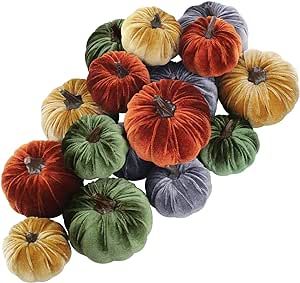 a group of pumpkins sitting on top of each other in different colors and sizes