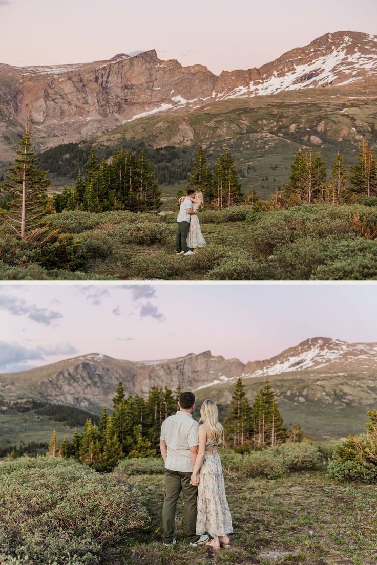 a couple standing on top of a lush green hillside