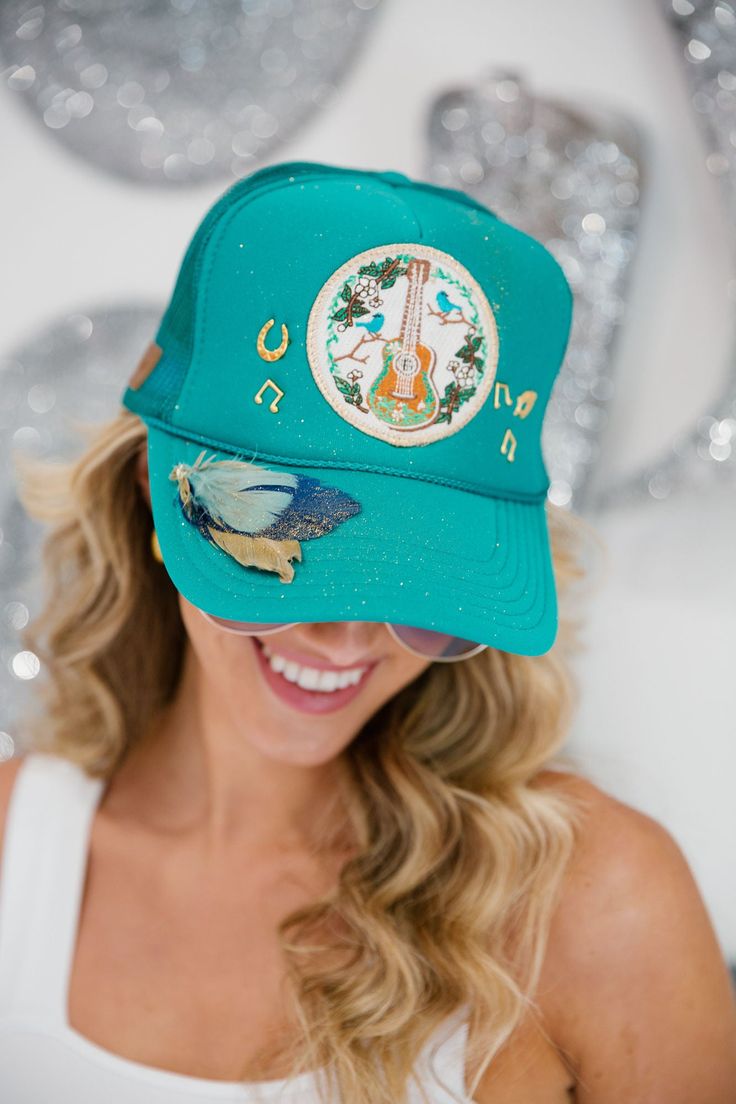 This Acoustic Trucker Hat is a unique combination of feather, glitter, and custom pins. With the ability to be custom-made, you can stand out from the crowd in its vibrant turquoise hue. It offers a stylish, custom-made look for any occasion. This hat is one-of-a-kind, created by our owner Stephanie. This hat is currently offered with our glitter spray for our sparkle lovers, and it is offered without our glitter spray for the one's who like it a little less sparkly. All orders are currently shi Sparkle Spray, Glitter Spray, 30th Birthday, Custom Pins, Trucker Hat, Spray, Sparkle, Glitter, Turquoise