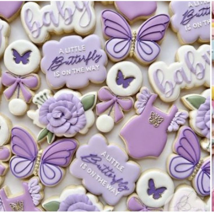 some cookies are decorated with purple and white icing