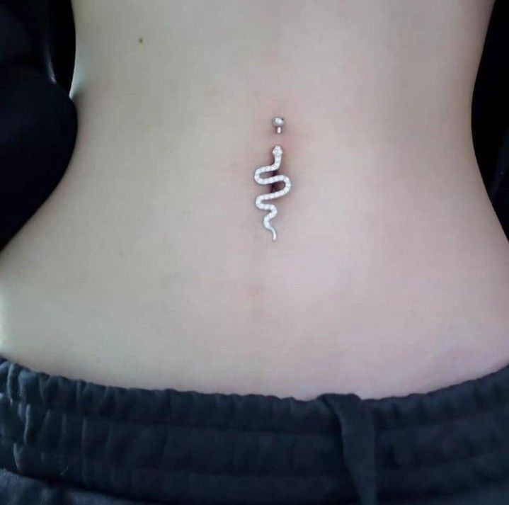 a woman's stomach with a white snake tattoo on the side, and an inscription that reads from buyer