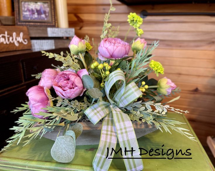 a bouquet of flowers sitting on top of a green box