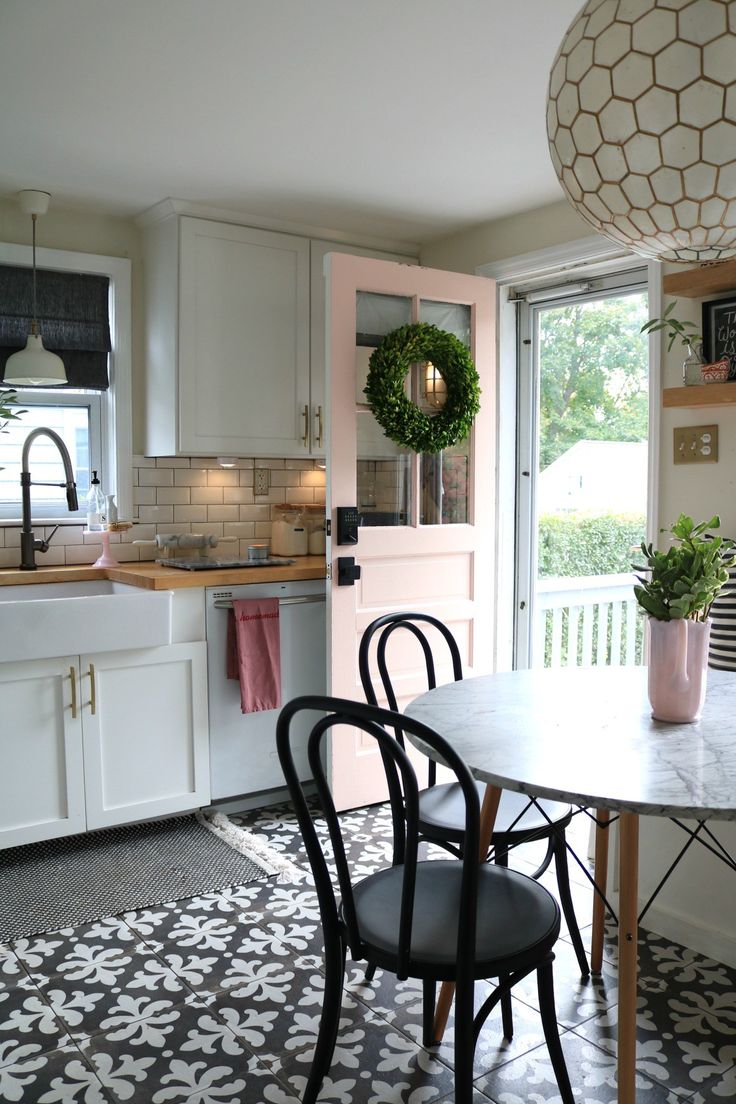 a kitchen with a table, chairs and a potted plant on the counter top