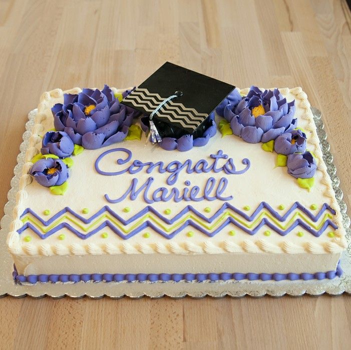 a graduation cake with purple flowers and a black cap on top that says congrats marielle