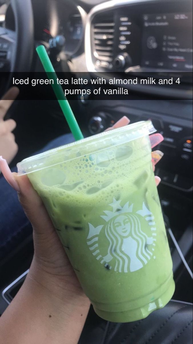 a person holding a green drink in their hand with the caption iced green tea with almond milk and 4 pumps of vanilla