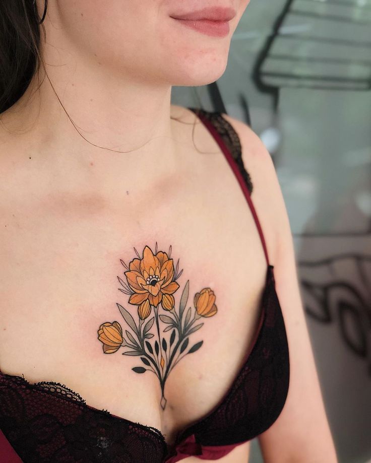 a woman with a flower tattoo on her chest