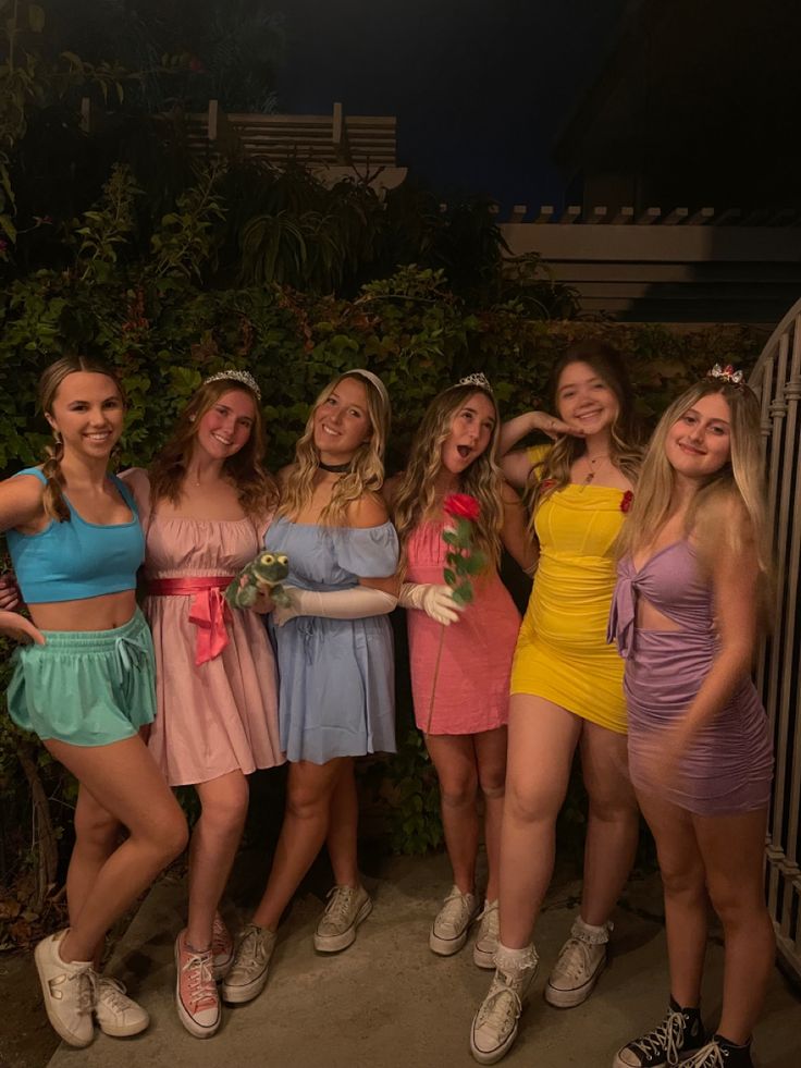 the girls are all dressed up and posing together