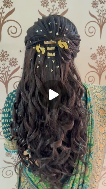 the back of a woman's head with long hair and gold stars on it