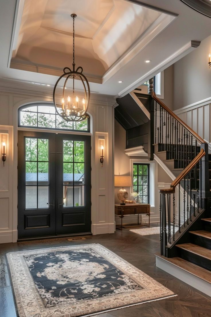 a foyer with stairs, chandelier and door leading up to the second floor