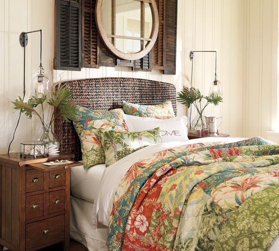 a bed sitting under a mirror in a bedroom