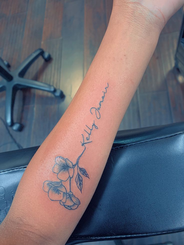 a woman's arm with a tattoo on it that reads, faith and flowers