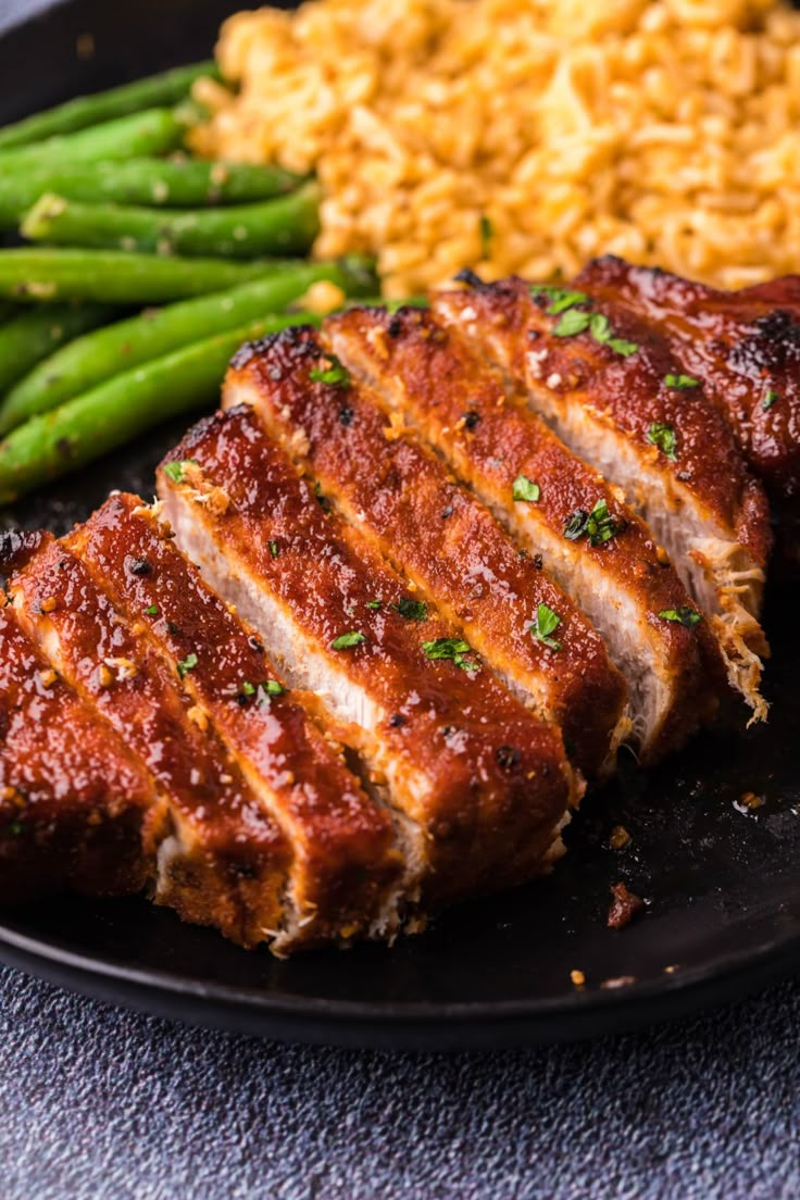 meat, rice and asparagus on a plate ready to be eaten for dinner