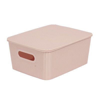 a pink storage box with a brown stripe pattern on the front and bottom, sitting against a white background