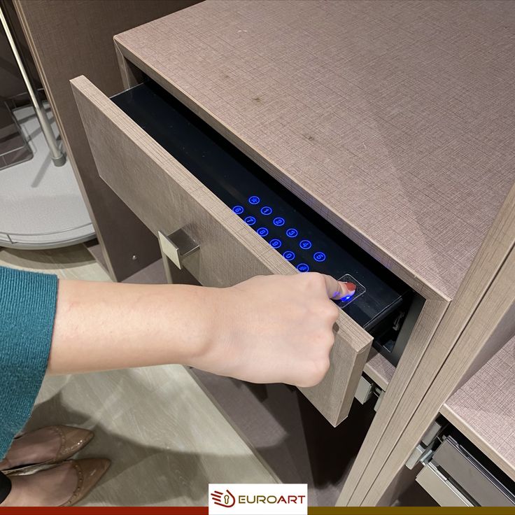 a person opening a drawer with their hand on the door handle and finger pressing buttons