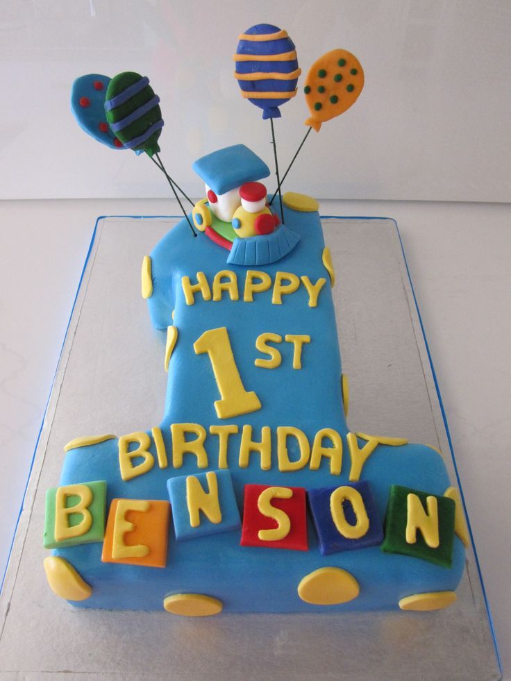 a blue birthday cake with balloons and the words happy 1st birthday benson