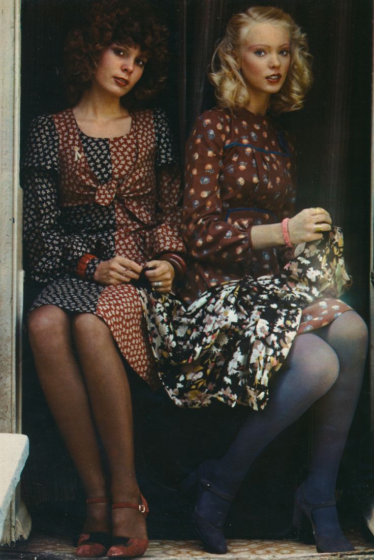 two women are sitting on the steps and one is wearing a dress with polka dots