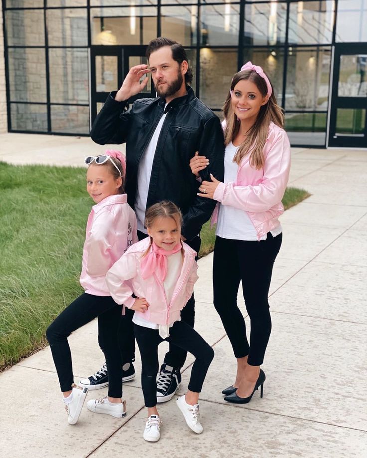 a man and two women posing for a photo with their children in pink outfits on instagram