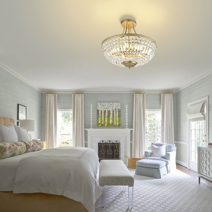 a bedroom with a bed, chair and chandelier in the middle of it