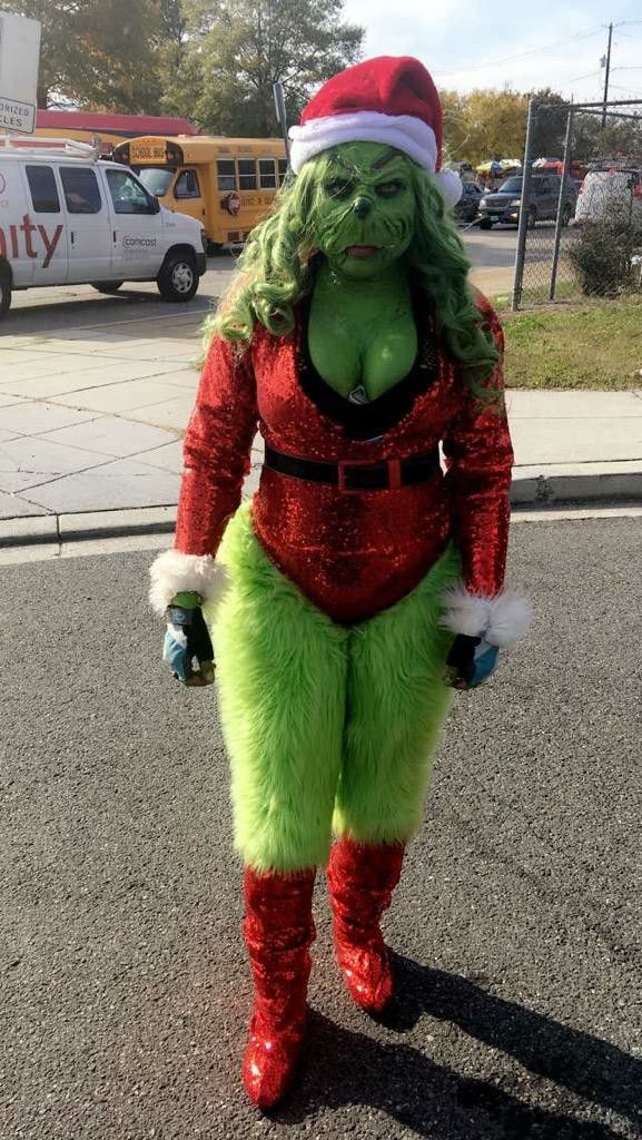 a woman dressed as the grin costume is standing in the street with her hands on her hips