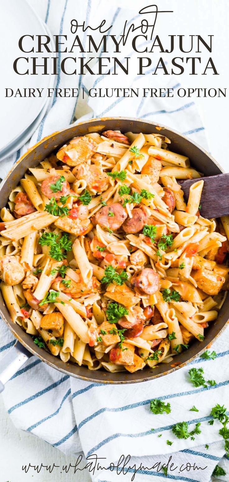 a skillet filled with chicken pasta and garnished with parsley on the side