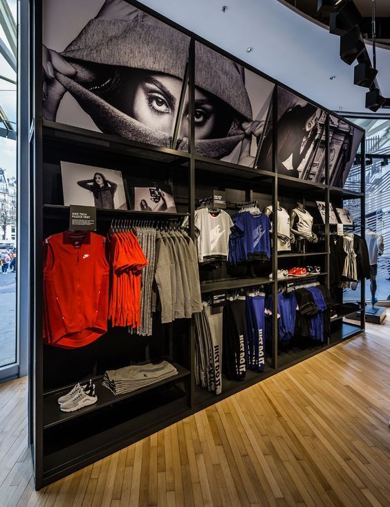 the inside of a clothing store with wooden floors