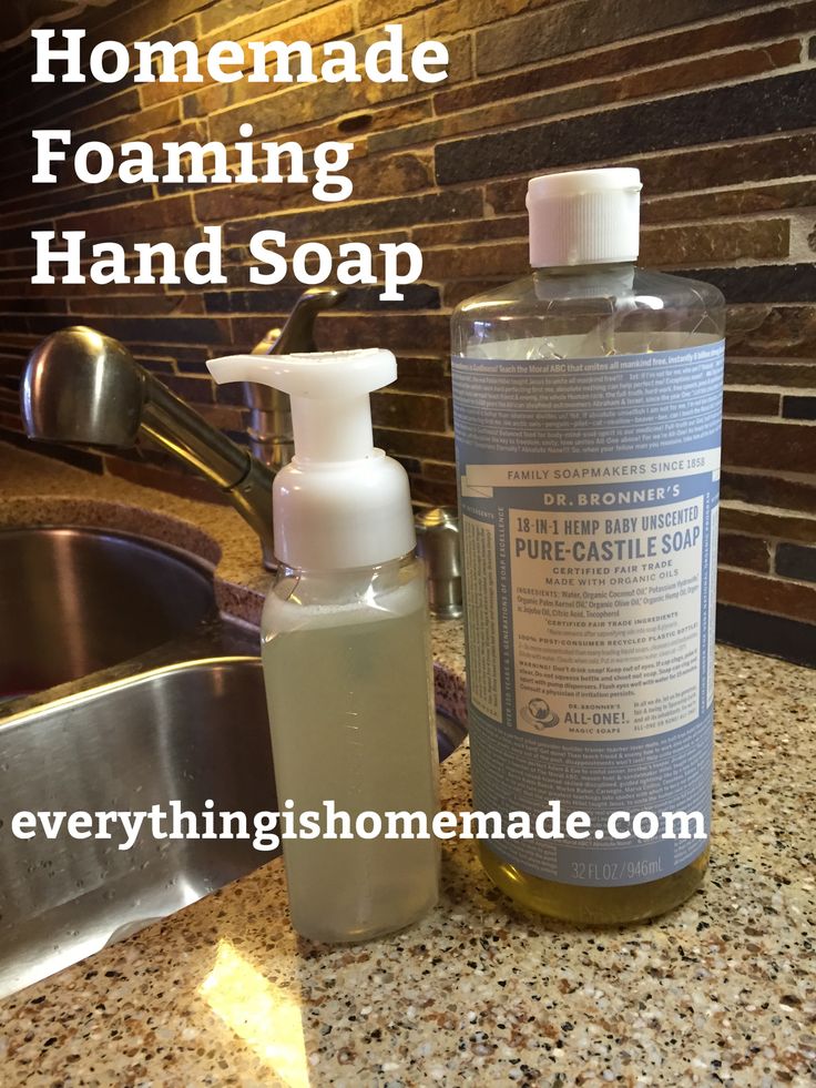 a bottle of soap sitting on top of a counter next to a sink and faucet