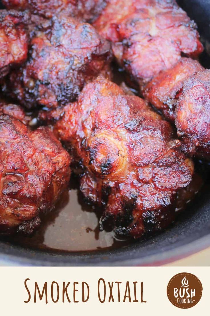 some meat is cooking in a pan with sauce on the side and text overlay that reads smoked oxtail