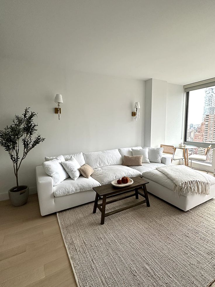 a living room with a large white sectional couch