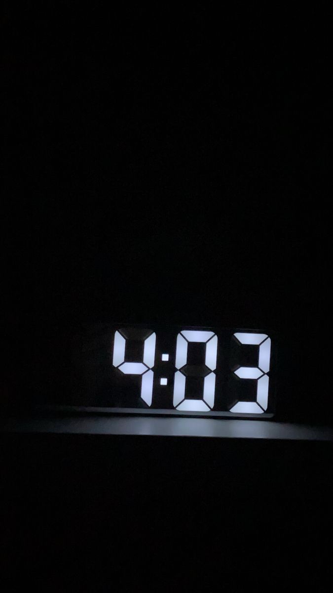 the digital clock is displayed in the dark