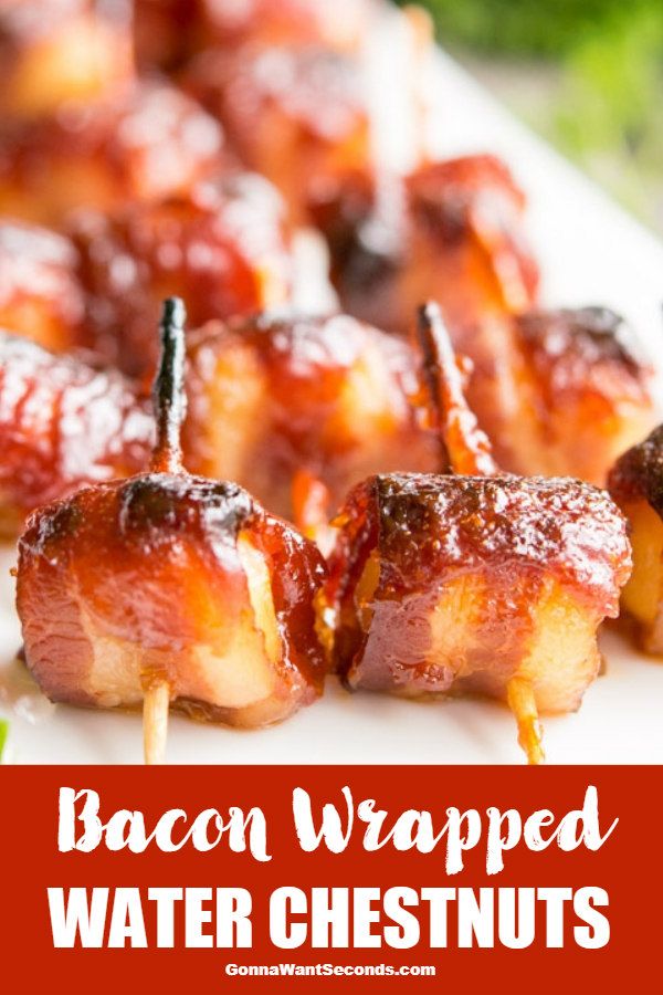 bacon wrapped water chestnuts on skewers with toothpicks in the middle