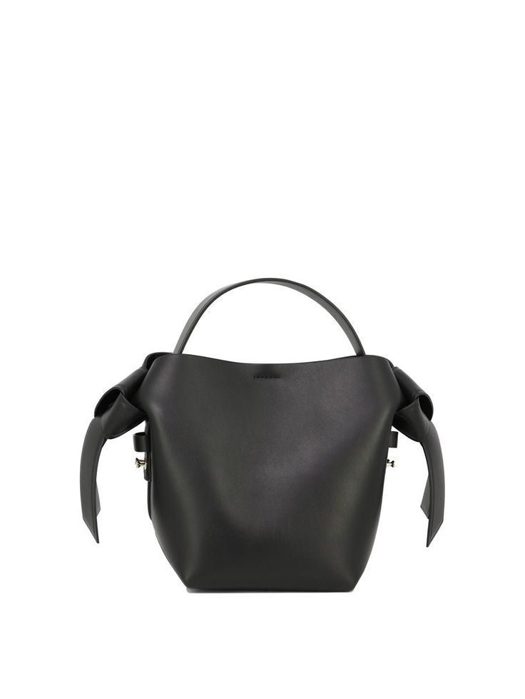 Acne Studios' handbag crafted in black smooth leather. It features gold-tone hardware, snap-button fastening, top handle and adjustable / removable shoulder strap. Tone-on-tone leather-lined interior with zip pocket. The design is completed by the unmistakable embossed logo on front and side knot details.Gender: WOMENMaterial: SHELL: 100% CALF LEATHER, LINING: 100% LAMB LEATHERColor: BLACKMade in: ITProduct ID: A10093900*Import tax/duty will be calculated at checkout (If applicable) Business Bucket Bag With Adjustable Strap And Top Handle, Business Bucket Bag With Top Handle And Adjustable Strap, Formal Bucket Bag With Handle Drop, Black Calf Leather Shoulder Bag With Gold-tone Hardware, Black Calf Leather Bucket Bag With Adjustable Strap, Chic Calf Leather Shoulder Bag With Handle Drop, Evening Hobo Bag With Gold-tone Hardware And Double Handle, Formal Bucket Bag With Top Carry Handle, Black Calf Leather Top Handle Bucket Bag