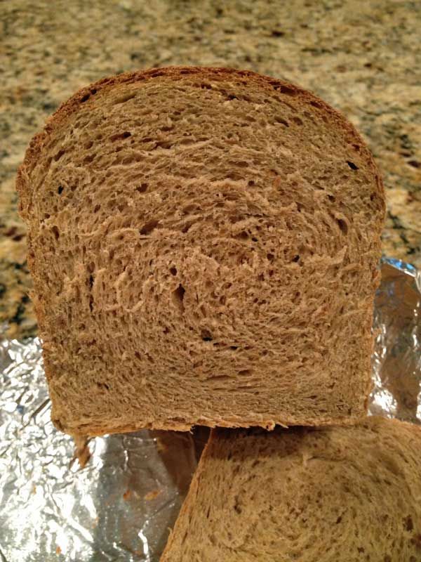 two pieces of brown bread sitting on top of aluminum foil covered in tinfoil next to a granite countertop