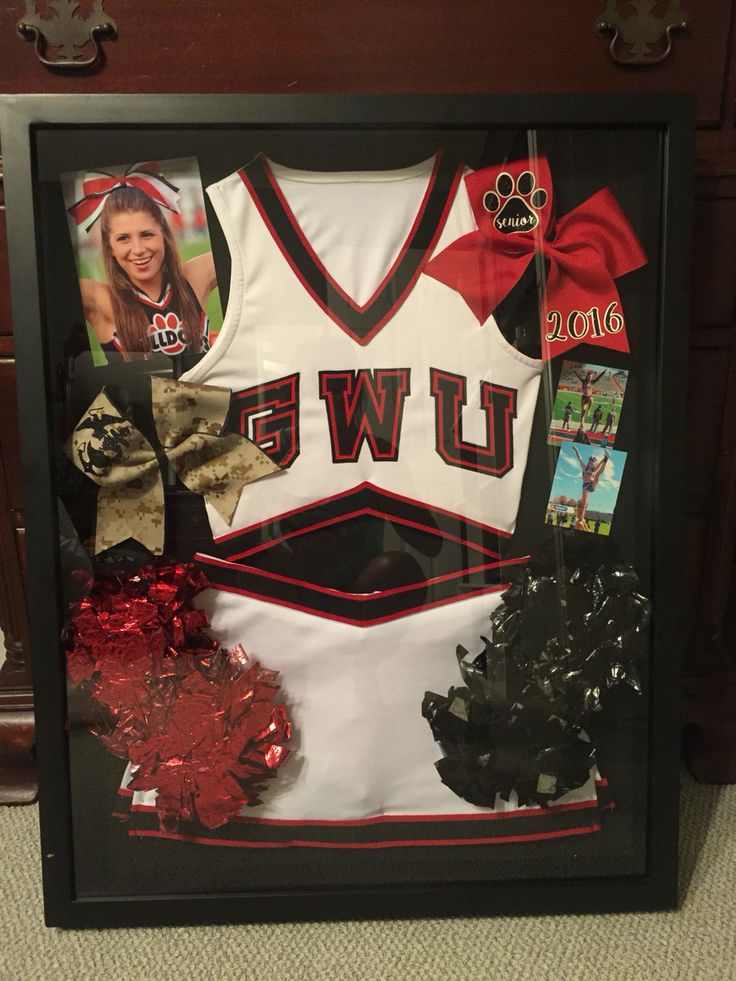 a sports jersey and cheerleader's hair is on display in a shadow box