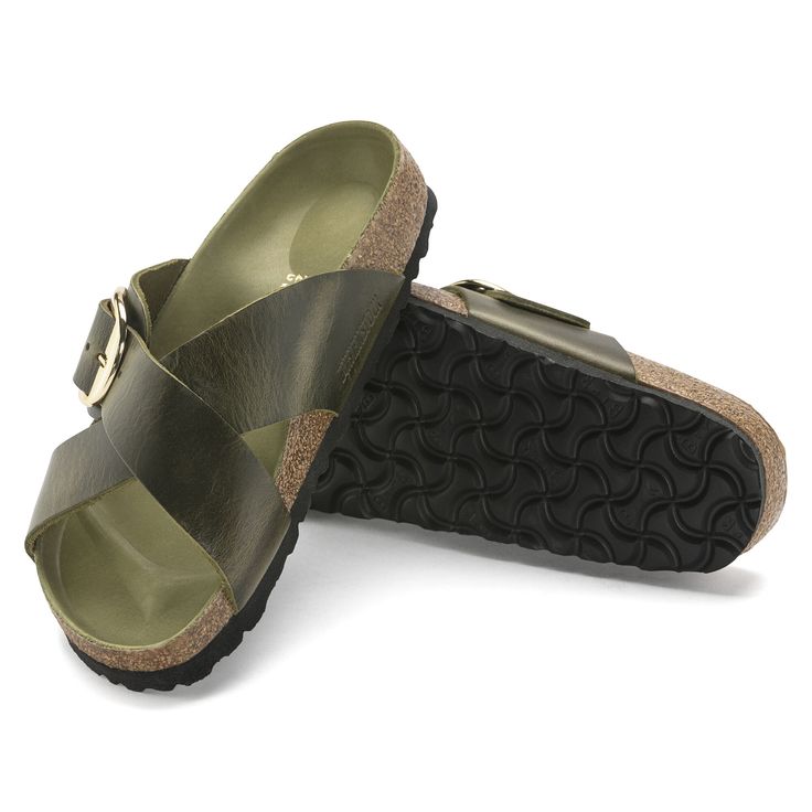 a pair of women's sandals with buckles on the front and back straps